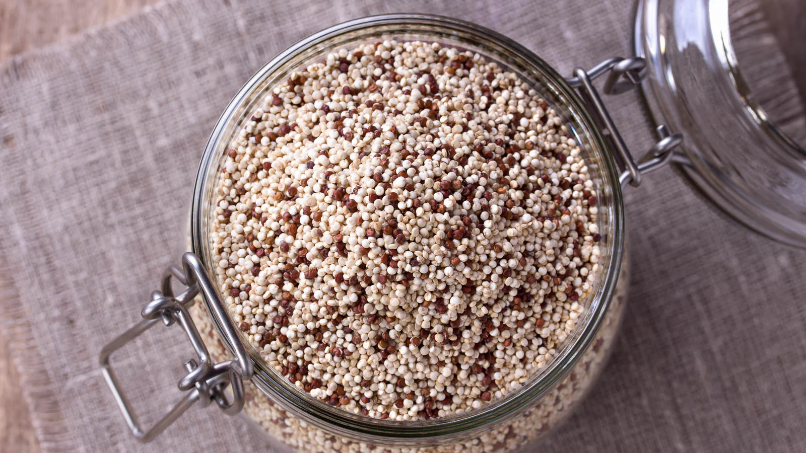Jar filled with dried quinoa seeds. 